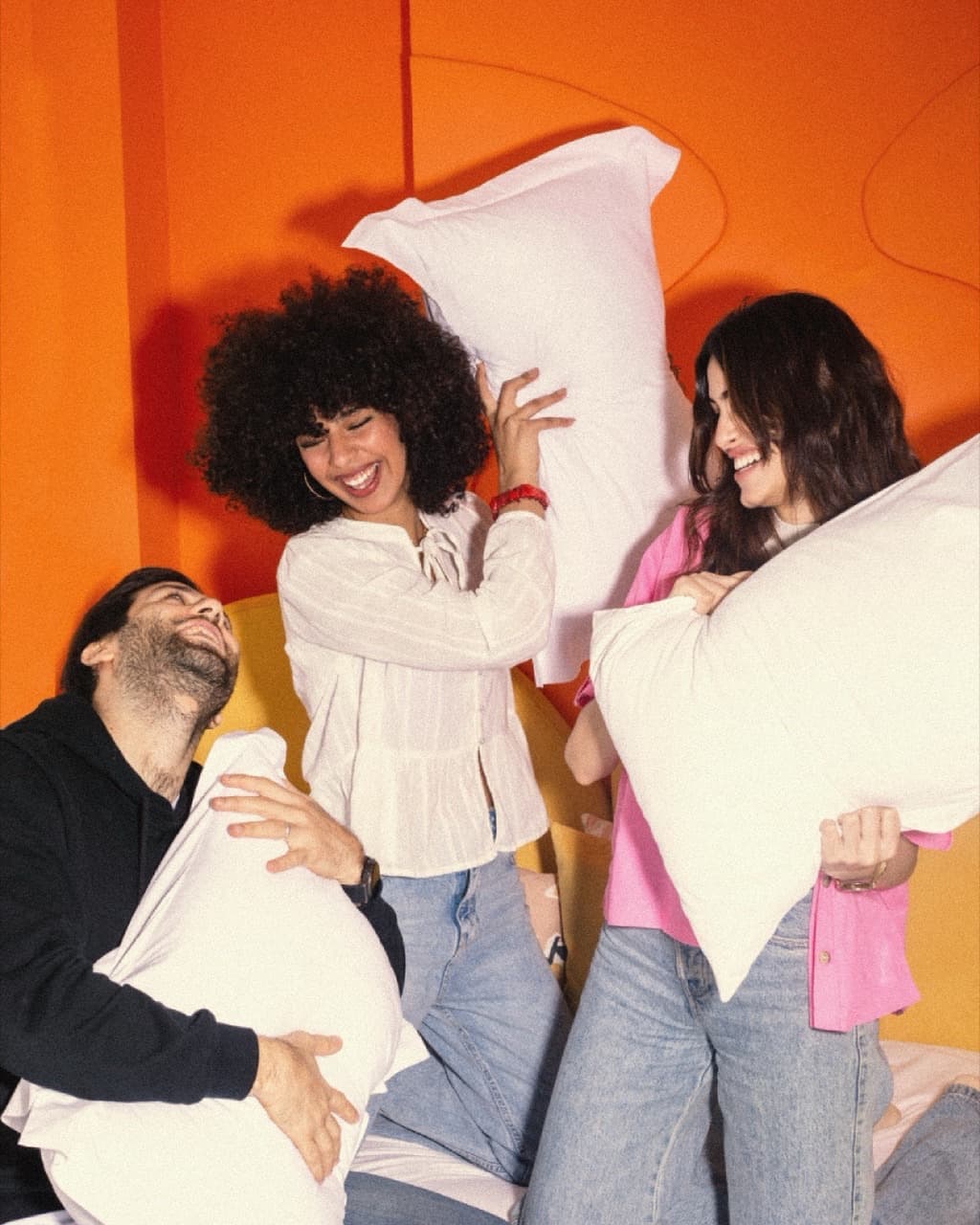 Friends having a pillow fight at StayHere